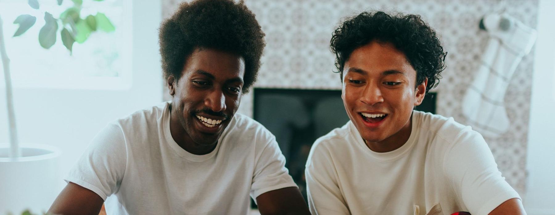 father and son sit together in living room