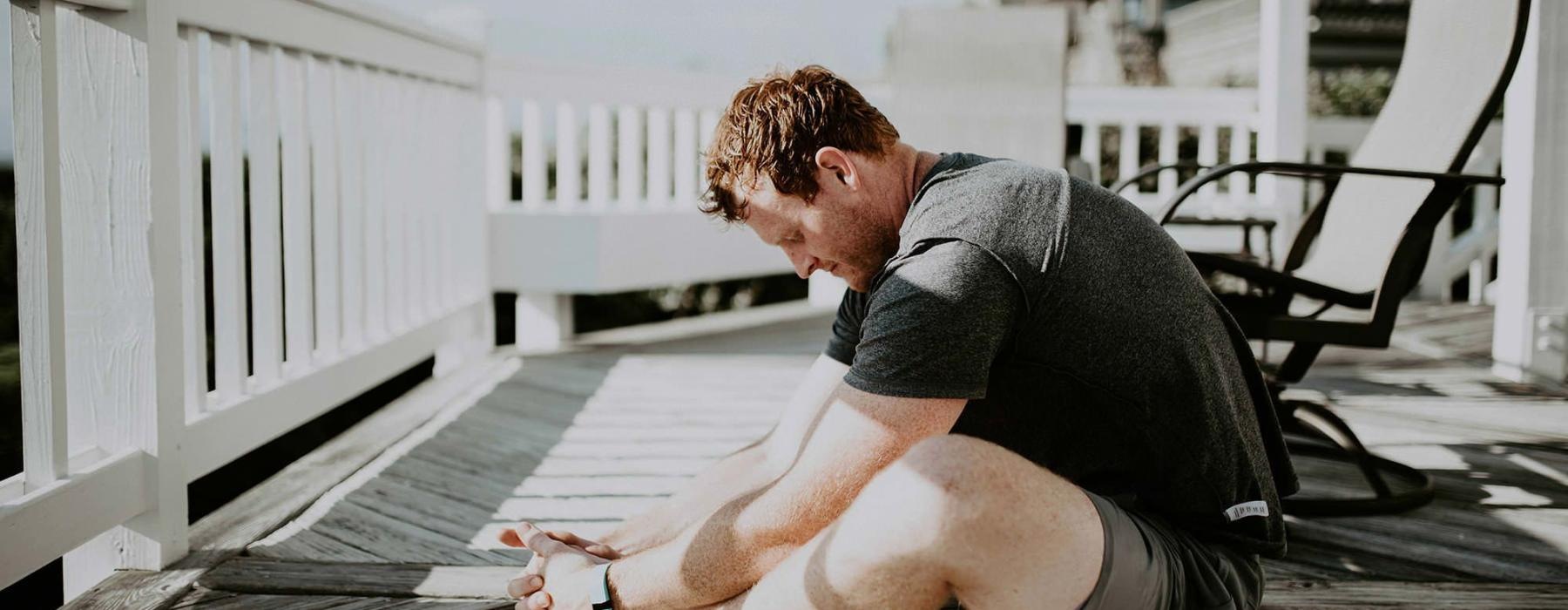 man stretching on a deck